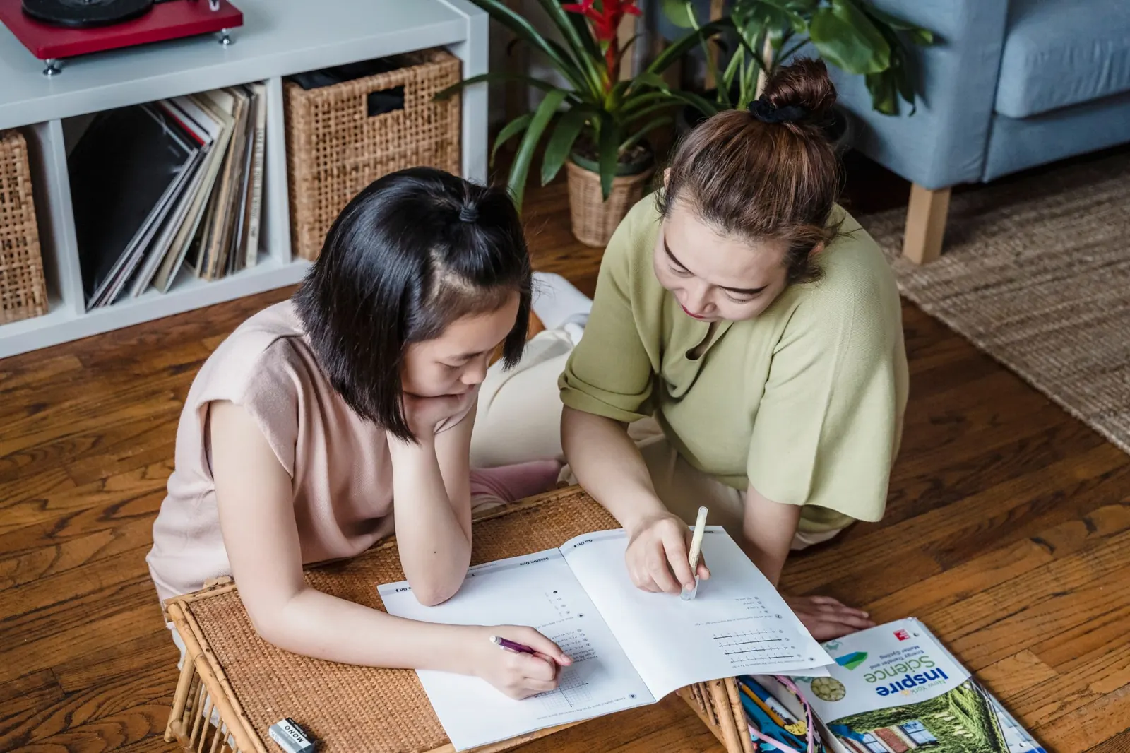 A mother helping her daughter with schoolwork at home